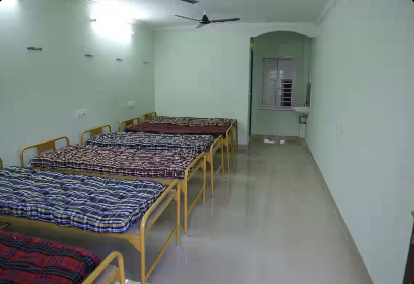 Non-AC 6 sharing room with bunk beds and lockers at Amigos Gents Hostel, Labbipet, Vijayawada