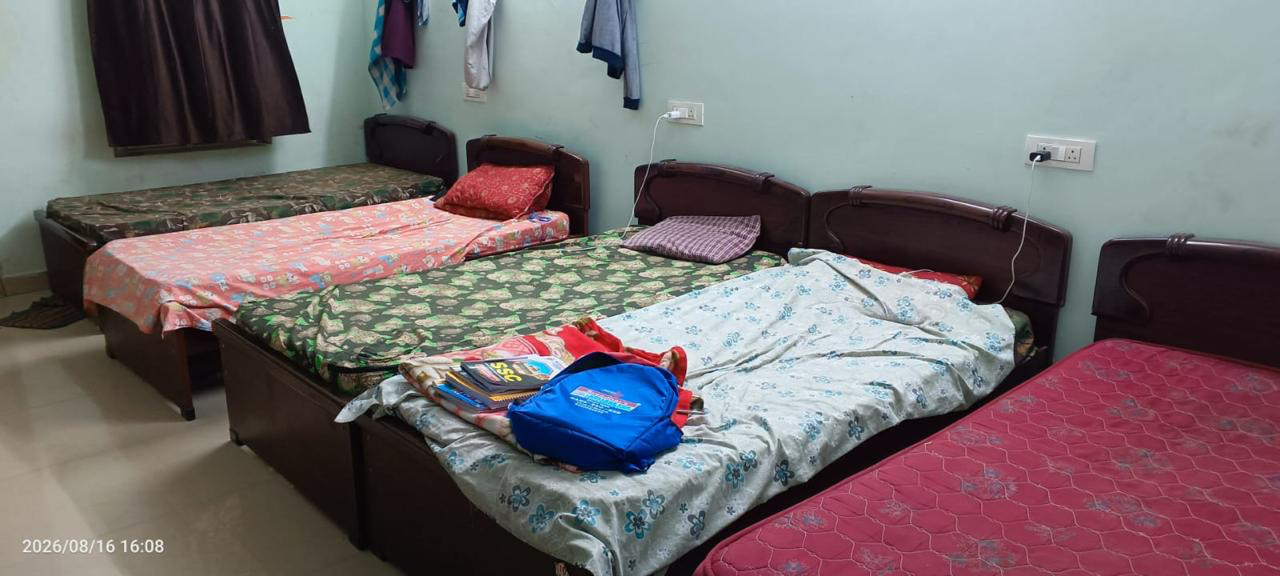 Air-conditioned 5 sharing room with single beds at Amigos Gents Hostel, Labbipet, Vijayawada
